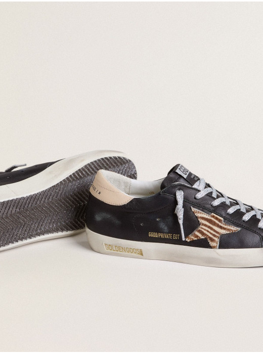 Women’s Super-Star in black nappa leather with zebra-print pony skin star and beige leather heel tab