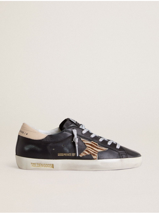 Women’s Super-Star in black nappa leather with zebra-print pony skin star and beige leather heel tab